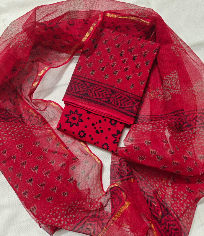 Red Kota Doria suit featuring black floral hand block prints and a Zari border.