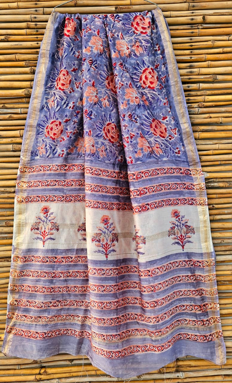 Blue and white Maheshwari silk cotton blend hand block print saree with a red floral pallu design and gold zari border.
