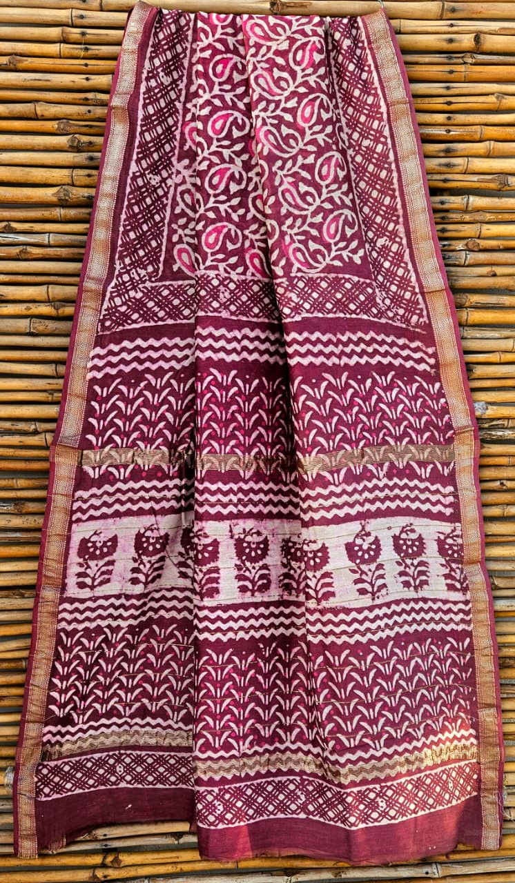 maroon and off-white hand-block printed Maheshwari silk-cotton blend saree with a gold zari border.