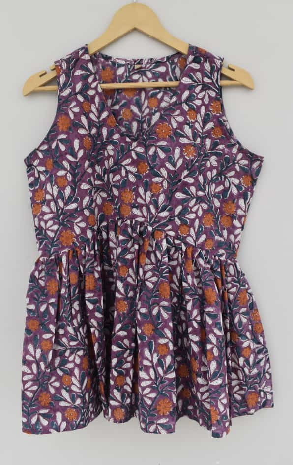 purple, orange, and white hand-block printed, floral or leaf pattern, cotton sleeveless peplum top.
