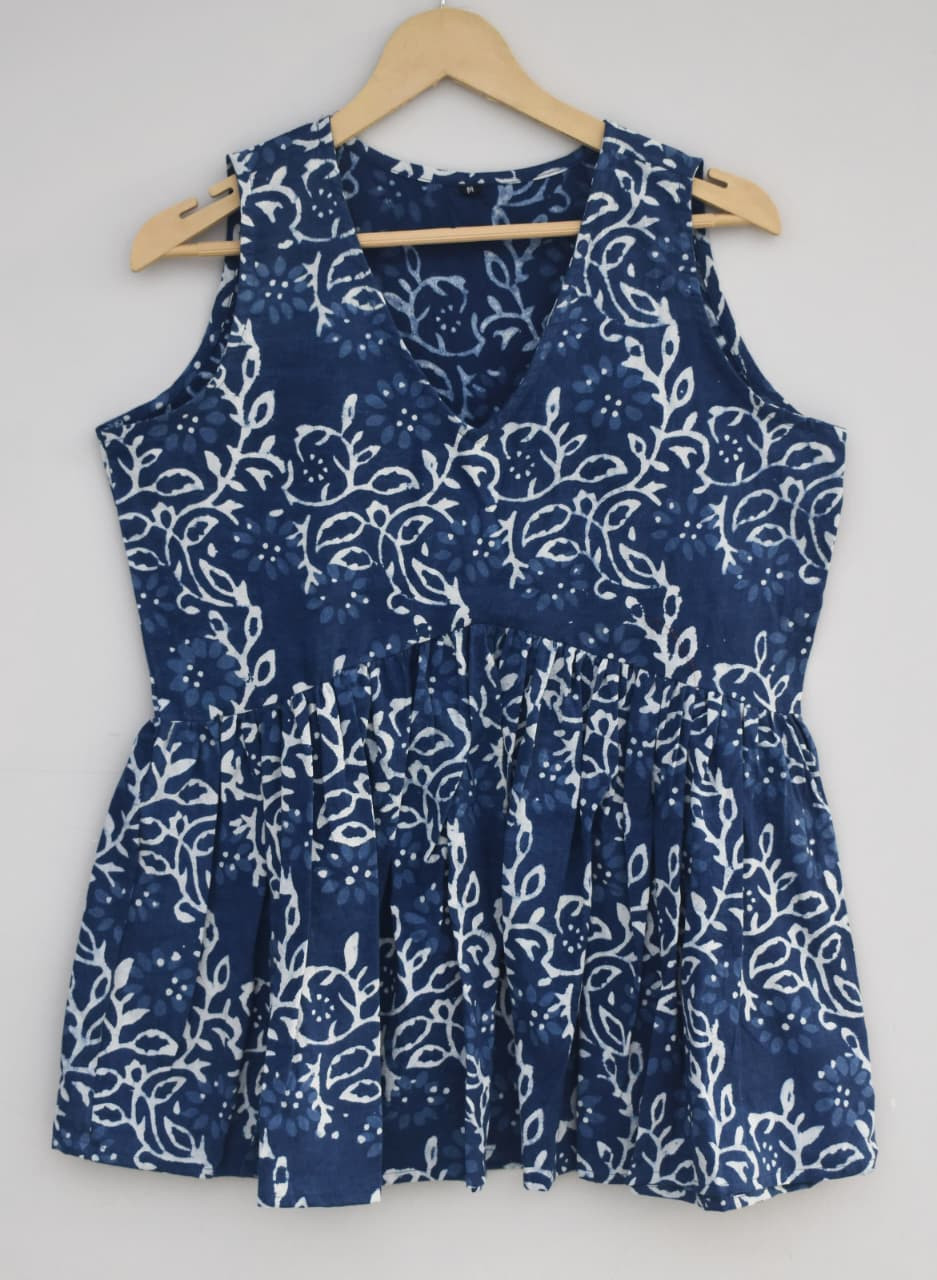 indigo blue, hand-block printed, cotton, sleeveless peplum top with a white abstract or floral pattern