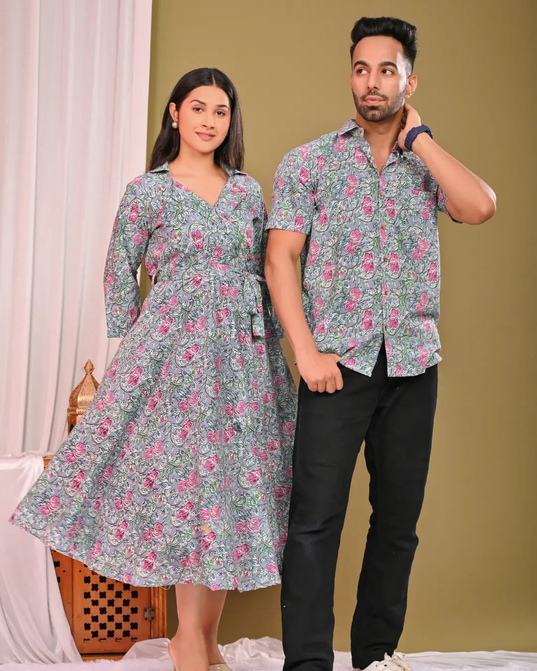A matching couple's outfit in a grey and pink floral print design