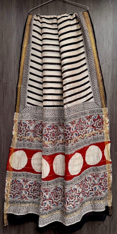 Black and white striped Maheshwari silk cotton blend saree with red and white printed pallu and gold zari border.