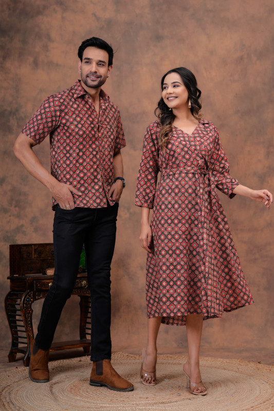 A matching couple's outfit in a black and red traditional hand block print design, made from a cotton material