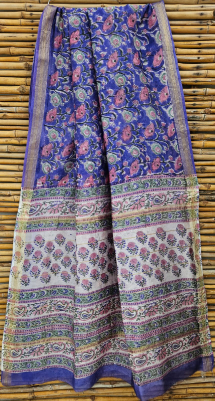 Blue and white Maheshwari silk cotton blend hand block print saree with a red floral pallu design and gold zari border.