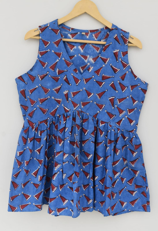 blue, sleeveless peplum top with a red and white Santa hat print.