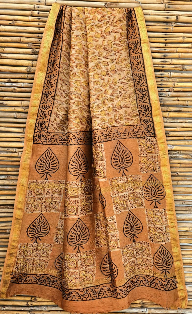 beige and brown hand-block printed Maheshwari silk/cotton blend saree with traditional leaf and floral motifs and a golden zari border