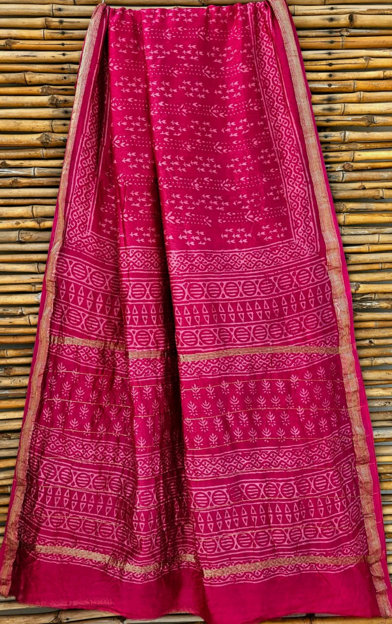 hot pink Maheshwari silk/cotton handloom saree with hand-block printing and a golden zari border.