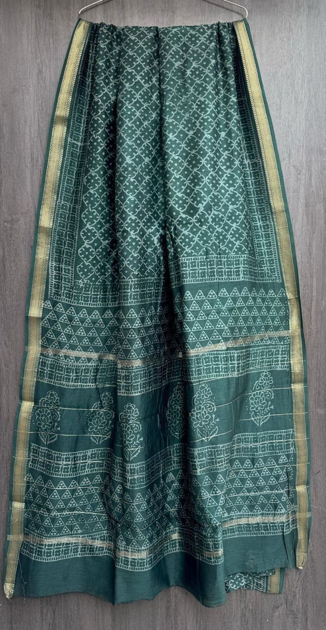 Dark green Maheshwari silk cotton blend hand block print saree with a gold zari border and traditional motifs.