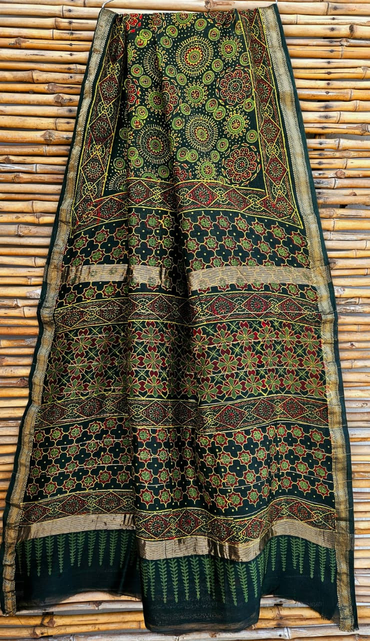 dark green hand-block printed Ajrakh or Maheshwari silk/cotton blend saree featuring traditional red and green motifs and a golden zari border