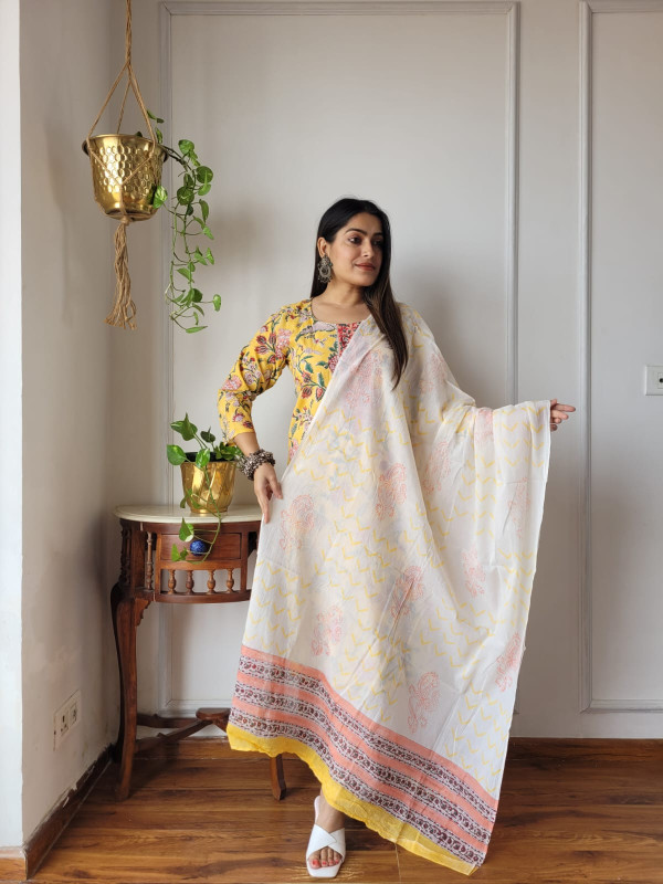 yellow and white hand block printed cotton kurta, pants, and dupatta suit set.