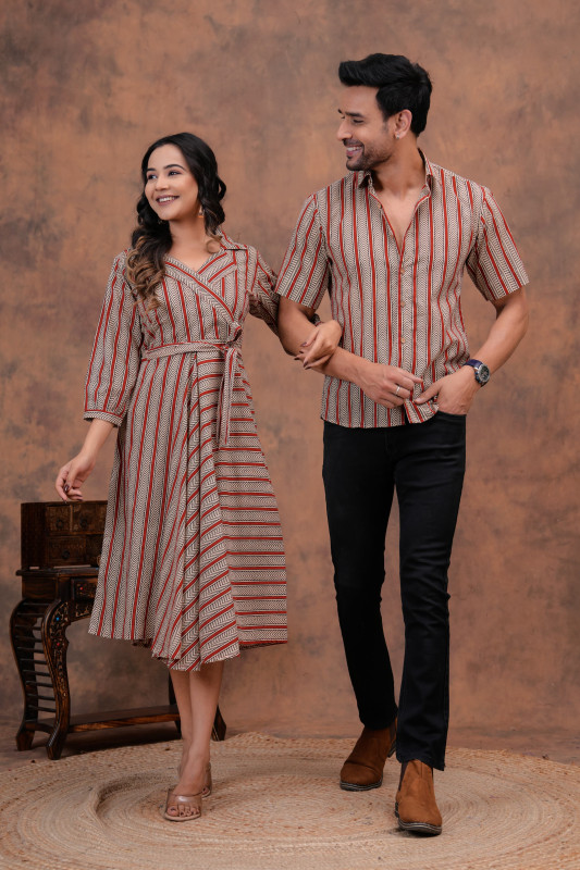 A matching couple's outfit in a red, off-white, and black striped print design, made from a cotton material